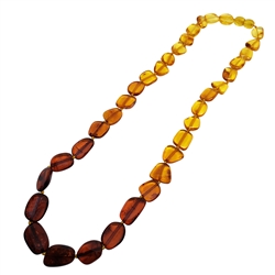 20â€³ Multi-Color Amber Rainbow Beaded Necklace. Flat freeform amber beads are set on a durable string, finished with a screw clasp. Genuine Baltic amber necklace.