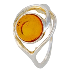 An oval of honey amber set in an artistic swirl of sterling silver.