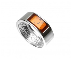A nice display of honey amber set in a sterling silver band. Band width is approx 0.25" wide. Amber is soft, only slightly harder than talc, and should be treated with care.