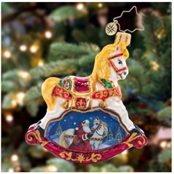 Shining in holiday colors of rich red, bright gold, emerald green and midnight blue, this ornate rocking horse embodies Chistmas tradition. The wintery vignitte beneath with Santa and his noble steed.
DIMENSIONS: 5.5 in (H) x 5 in (L) x 1.5 in (W)