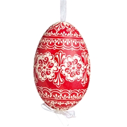 This beautifully designed egg is dyed one color, then white wax is melted and applied to form an intricate design which is left on the surfce. The egg is emptied and strung with ribbon for hanging.