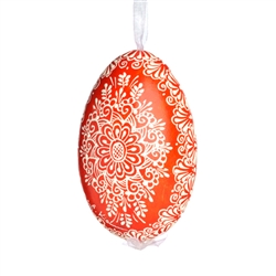 This beautifully designed egg is dyed one color, then white wax is melted and applied to form an intricate design which is left on the surfce. The egg is emptied and strung with ribbon for hanging.