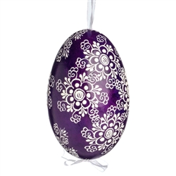 This beautifully designed egg is dyed one color, then white wax is melted and applied to form an intricate design which is left on the surfce. The egg is emptied and strung with ribbon for hanging.