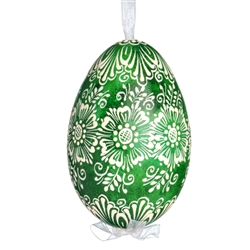 This beautifully designed egg is dyed one color, then white wax is melted and applied to form an intricate design which is left on the surfce. The egg is emptied and strung with ribbon for hanging.