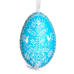 This beautifully designed egg is dyed one color, then white wax is melted and applied to form an intricate design which is left on the surfce. The egg is emptied and strung with ribbon for hanging.