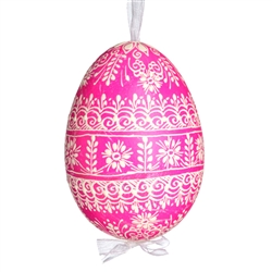 This beautifully designed egg is dyed one color, then white wax is melted and applied to form an intricate design which is left on the surfce. The egg is emptied and strung with ribbon for hanging.