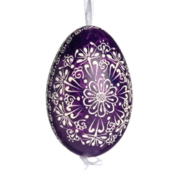 This beautifully designed egg is dyed one color, then white wax is melted and applied to form an intricate design which is left on the surfce. The egg is emptied and strung with ribbon for hanging.