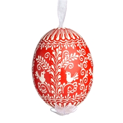 This beautifully designed egg is dyed one color, then white wax is melted and applied to form an intricate design which is left on the surfce. The egg is emptied and strung with ribbon for hanging.