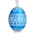 This beautifully designed egg is dyed one color, then white wax is melted and applied to form an intricate design which is left on the surfce. The egg is emptied and strung with ribbon for hanging.