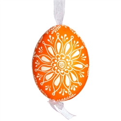 This beautifully designed egg is dyed one color, then white wax is melted and applied to form an intricate design which is left on the surfce. The egg is emptied and strung with ribbon for hanging.