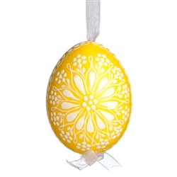 This beautifully designed egg is dyed one color, then white wax is melted and applied to form an intricate design which is left on the surfce. The egg is emptied and strung with ribbon for hanging.