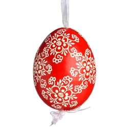 This beautifully designed egg is dyed one color, then white wax is melted and applied to form an intricate design which is left on the surfce. The egg is emptied and strung with ribbon for hanging.