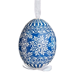 This beautifully designed egg is dyed one color, then white wax is melted and applied to form an intricate design which is left on the surfce. The egg is emptied and strung with ribbon for hanging.