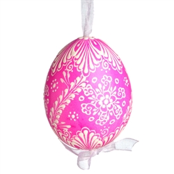 This beautifully designed egg is dyed one color, then white wax is melted and applied to form an intricate design which is left on the surfce. The egg is emptied and strung with ribbon for hanging.