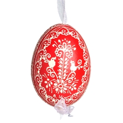 This beautifully designed egg is dyed one color, then white wax is melted and applied to form an intricate design which is left on the surfce. The egg is emptied and strung with ribbon for hanging.