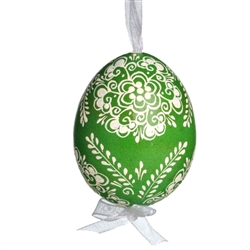 This beautifully designed egg is dyed one color, then white wax is melted and applied to form an intricate design which is left on the surfce. The egg is emptied and strung with ribbon for hanging.