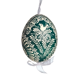 This beautifully designed egg is dyed one color, then white wax is melted and applied to form an intricate design which is left on the surfce. The egg is emptied and strung with ribbon for hanging.