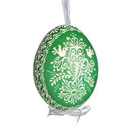 This beautifully designed egg is dyed one color, then white wax is melted and applied to form an intricate design which is left on the surfce. The egg is emptied and strung with ribbon for hanging.