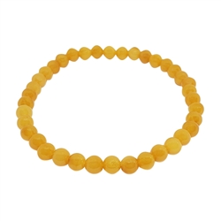 Butterscotch Amber Stretch Bracelet. Round-shaped amber beads set on elastic cord. Genuine Baltic amber bracelet.  Please note that the amber beads are perfectly calibrated. 5-5.5 mm in diameter round beads.