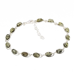 Green Amber .925 Silver Link Bracelet. Oval shaped amber stones set in .925 sterling silver. The bracelet has an extension chain. Length is 7.5" long including the extender chain.