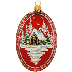 A lone cabin in the woods is blanketed in snow and shimmers with colorful glitter accents upon this unique red oval medallion. 4" glass ornament is skillfully handmade in Poland and features a trio of snowy pine trees on reverse side.