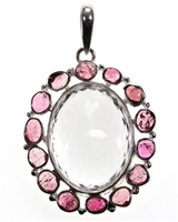 clear quartz faceted oval stone with 14 pink tourmaline surrounding pebble stones 2-1/4" commanding piece