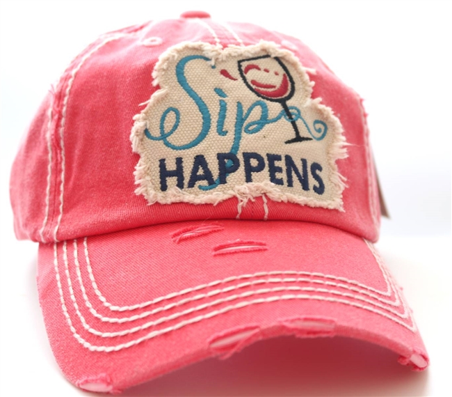ponytail cap says sip happens with wine glass in front distressed style coral color