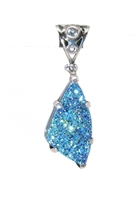 Druzy quartz, free-form angular shaped pendant.  Iridescent blues with white topaz filigree topper.  backside is filigree and quite beautiful. 1-3/4" in sterling silver setting.
