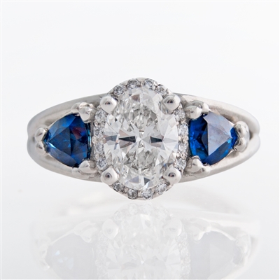 three stone oval halo diamond ring with trillion sapphires