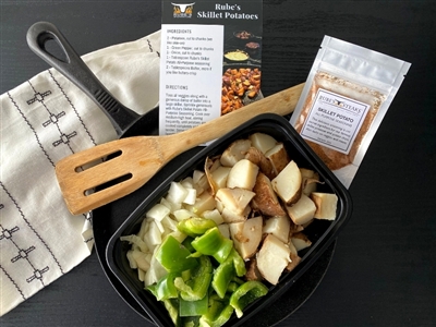 Skillet potato kit, recipe, and seasoning in a pan ready for the stovetop