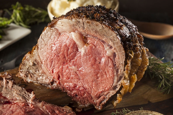 Close up photo of a medium rare prime rib roast.