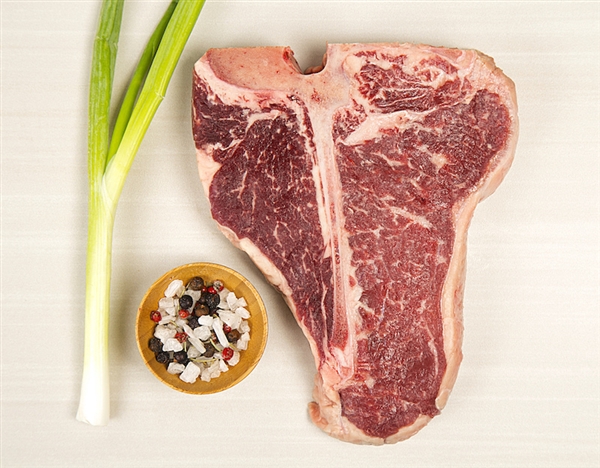 Tbone with seasoning and a green onion