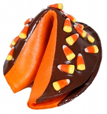 Orange giant fortune cookie covered in dark chocolate topped with candy corn.