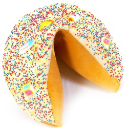 Gigantic fortune cookie covered in chocolate and decorated with pink, blue, yellow and white to welcome the new baby and congratulate the parents.