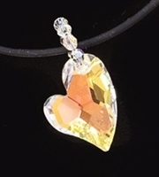Devoted 2 U Heart Crystalized with Swarovski hangs on a bias. The Classic Aurora Borealis coating shines a warm yellow to hot orange when worn on a dark color.