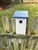 White Blue Bird House with navy roof made of composite material.  Hand made by a craftsman in the USA.