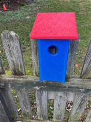 Navy Blue Bird House with a red roof made of composite material.  Hand made by a craftsman in the USA.