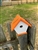 White Wren House with an orange roof made of composite material.  Hand made by a craftsman in the USA.
