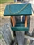 Cedar And Green Bird Feeder made of composite material. Holds 1 quart of seed. Hand made by a craftsman in the USA.