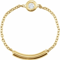 A 14k yellow gold link chain connects to a diamond set bezel in this 14k yellow ring.