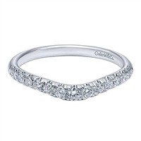This 14k white gold diamond wedding band is curved.