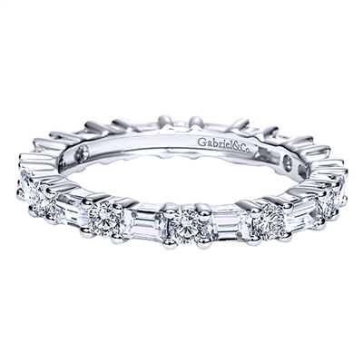With round and baguette cut diamonds, this 1.25 carat eternity band set in 14k white gold is a delightfully unique piece of wedding jewelry.