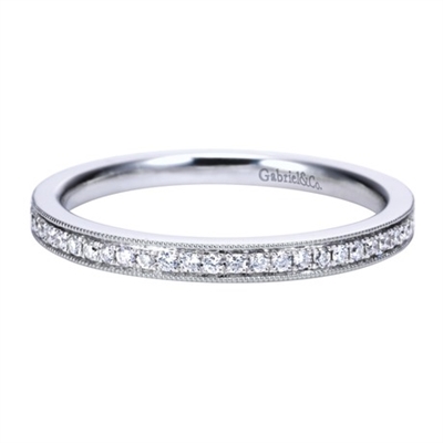 This 14k white gold diamond wedding band is simple but flashes elegantly with beaded white gold rows surrounding channel set round diamonds.