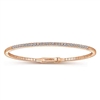 This diamond bangle bracelet in 14k rose gold boasts over one half carats of round brilliant diamonds that stand out over 14k rose gold.