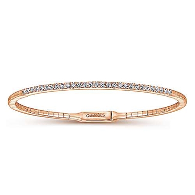 This diamond bangle bracelet in 14k rose gold boasts over one half carats of round brilliant diamonds that stand out over 14k rose gold.