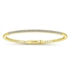 This 14k yellow gold diamond bangle features over one half carats of diamonds in a flexible