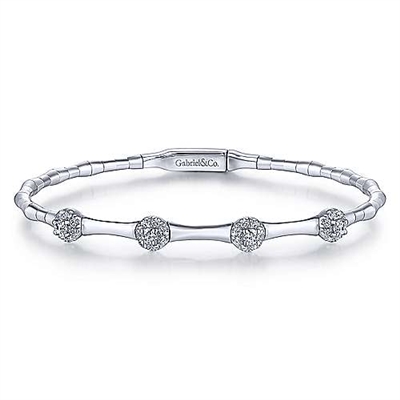 This station style white gold diamond bangle features cluster set diamond sections that total o.40 carats in diamonds, with bead style finishes in white gold down the bangle.