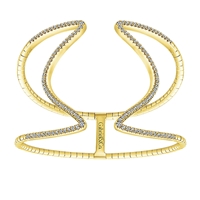 This curved yellow gold cuff features over one carat of round diamonds brilliantly emblazoned over 14k yellow gold in this large cuff bracelet.