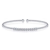 Round brilliant diamonds shimmer in this 14k white gold bezel set diamond cuff bangle style bracelet.