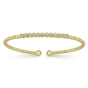 12 round diamonds align in this 14k yellow gold diamond cuff bracelet.